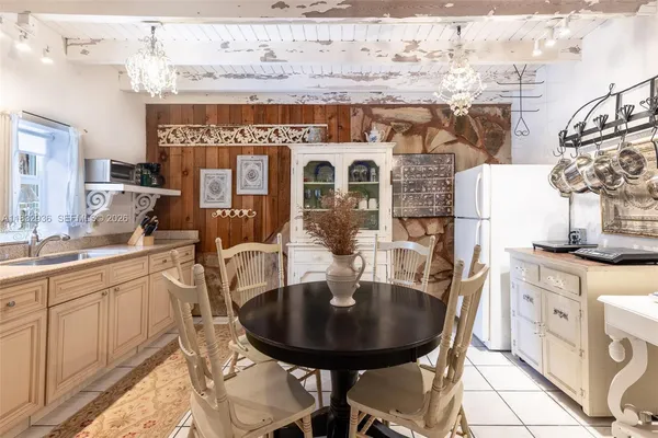 a view of a kitchen with a table and chairs