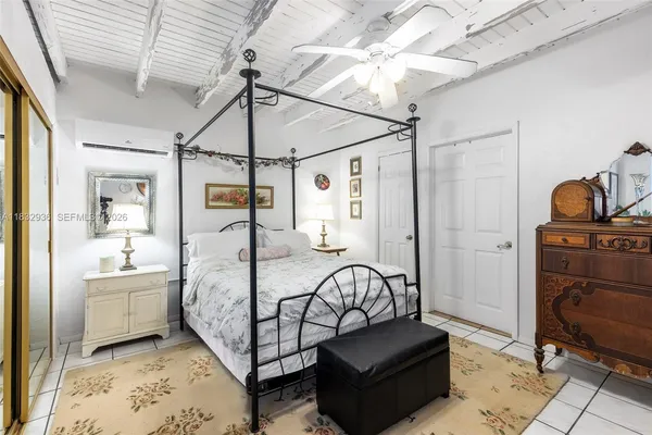 a bedroom with a bed and ceiling fan