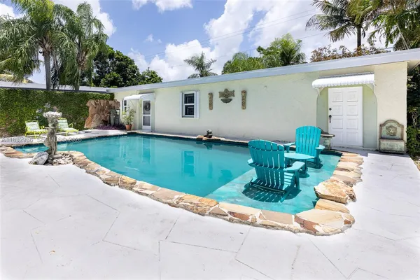 a swimming pool with outdoor seating and yard