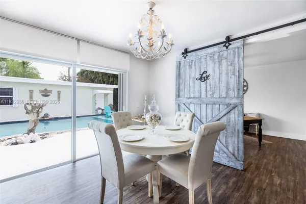 a view of a dining room with furniture wooden floor and chandelier