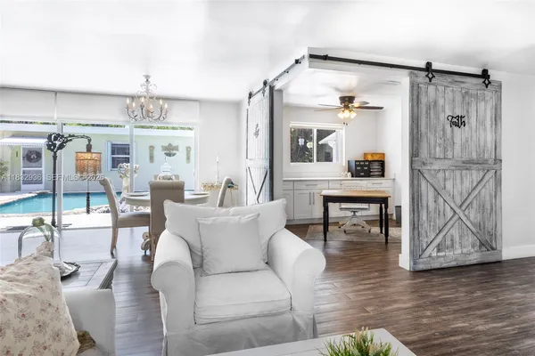 a living room with furniture and a chandelier
