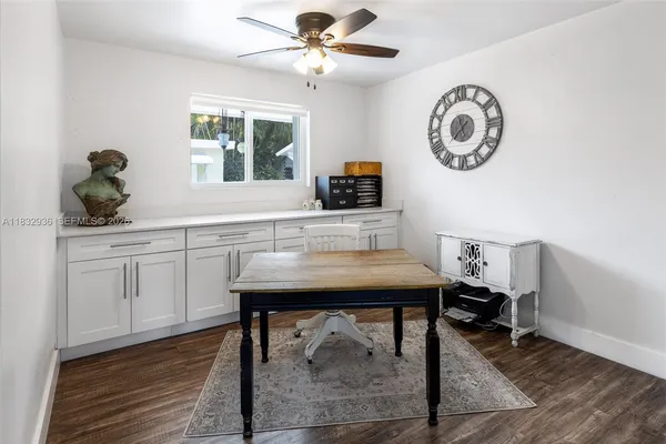 a room with a table chairs and a window