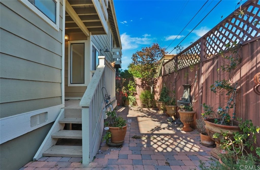 292 Palmer Street, Unit C2 Costa Mesa, CA 92627 - Photo 26 of 40 View of private patio and steps leading to Master Suite on 1st Level.