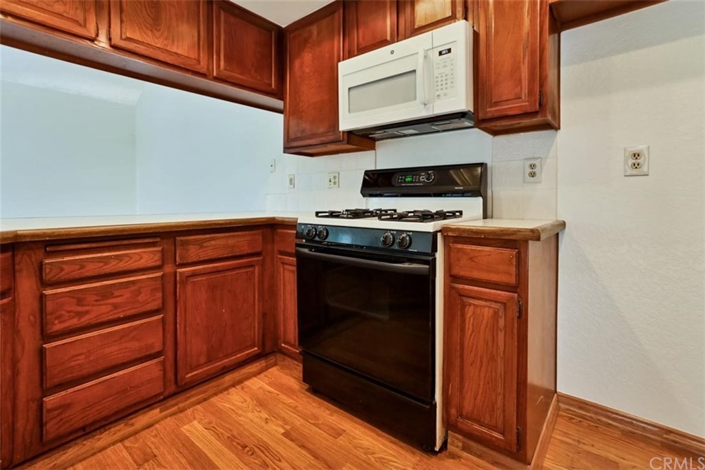 292 Palmer Street, Unit C2 Costa Mesa, CA 92627 - Photo 5 of 40 The Kitchen has lots of cabinet and counter space, along with a range, built in microwave and dishwasher.