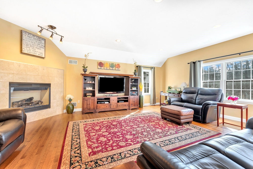 105 Hadley Road Merrimac, MA 01860 - Photo 11 of 31 a living room with furniture a flat screen tv and a fireplace