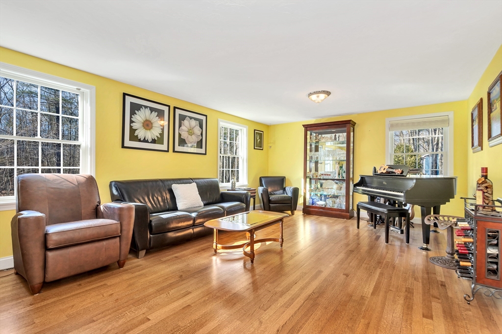 105 Hadley Road Merrimac, MA 01860 - Photo 13 of 31 a living room with furniture and a wooden floor