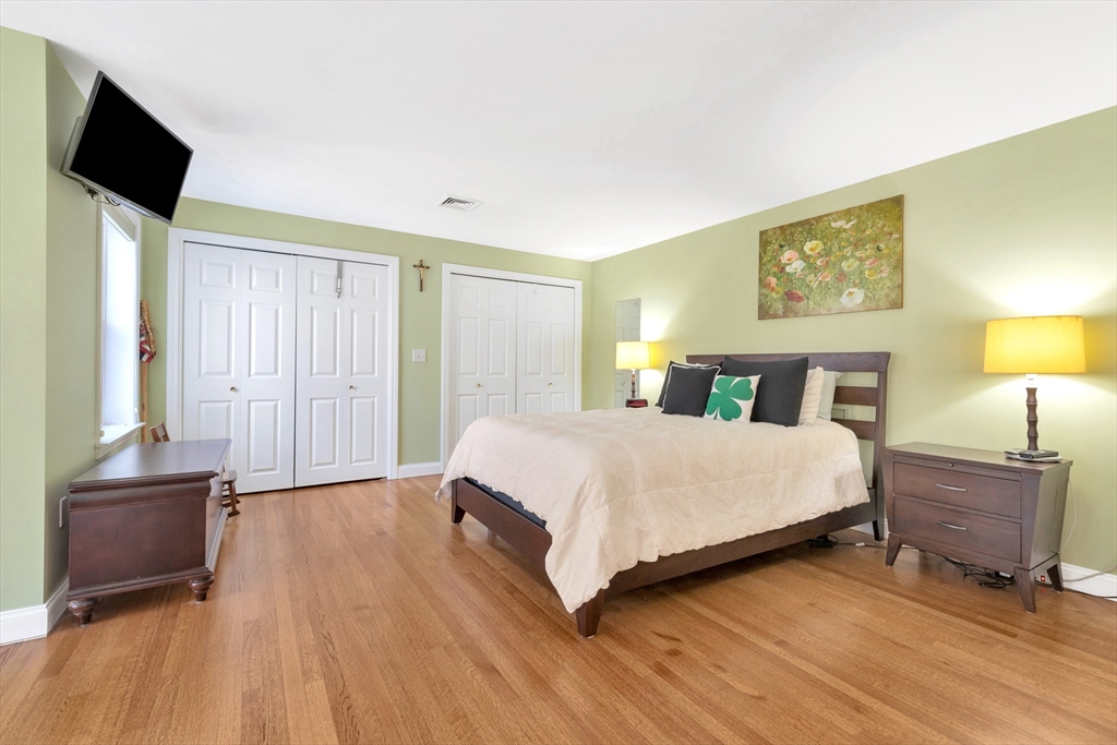 105 Hadley Road Merrimac, MA 01860 - Photo 19 of 31 a bedroom with a bed and wooden floor