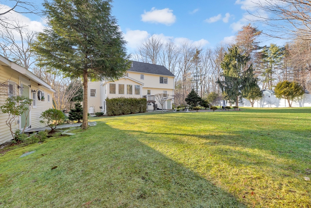 105 Hadley Road Merrimac, MA 01860 - Photo 27 of 31 a view of a house with a big yard and large trees