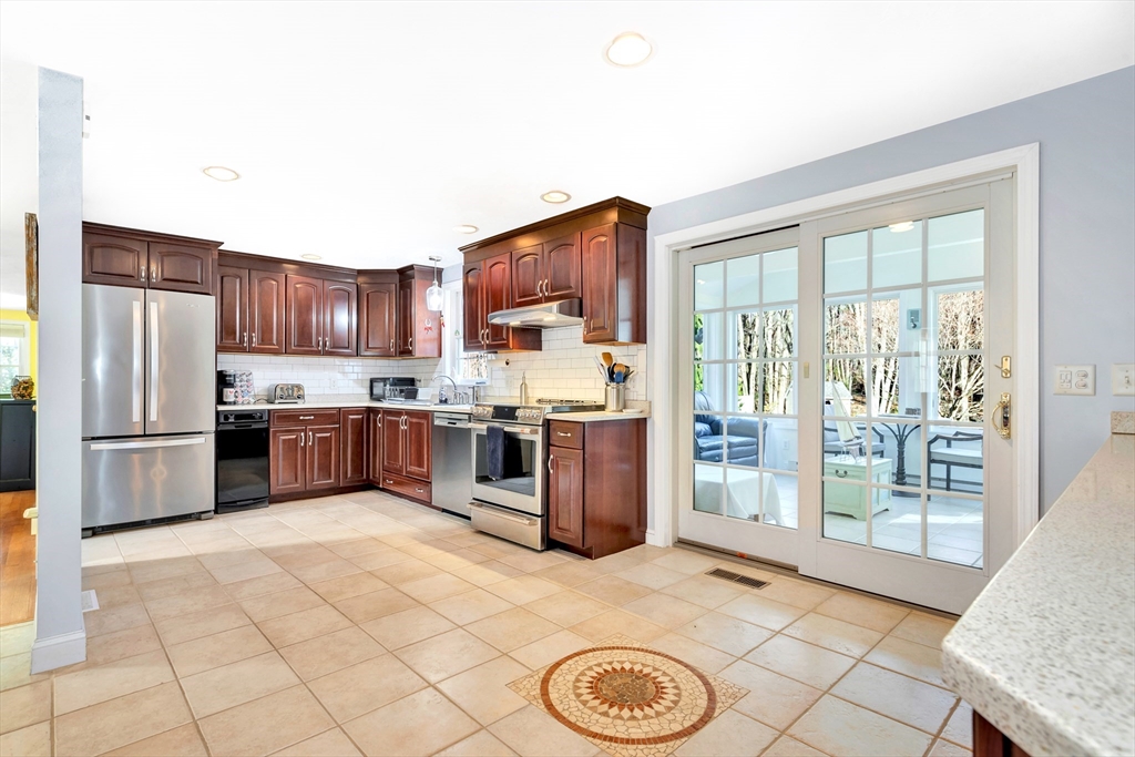 105 Hadley Road Merrimac, MA 01860 - Photo 7 of 31 a kitchen with stainless steel appliances a refrigerator and a stove top oven