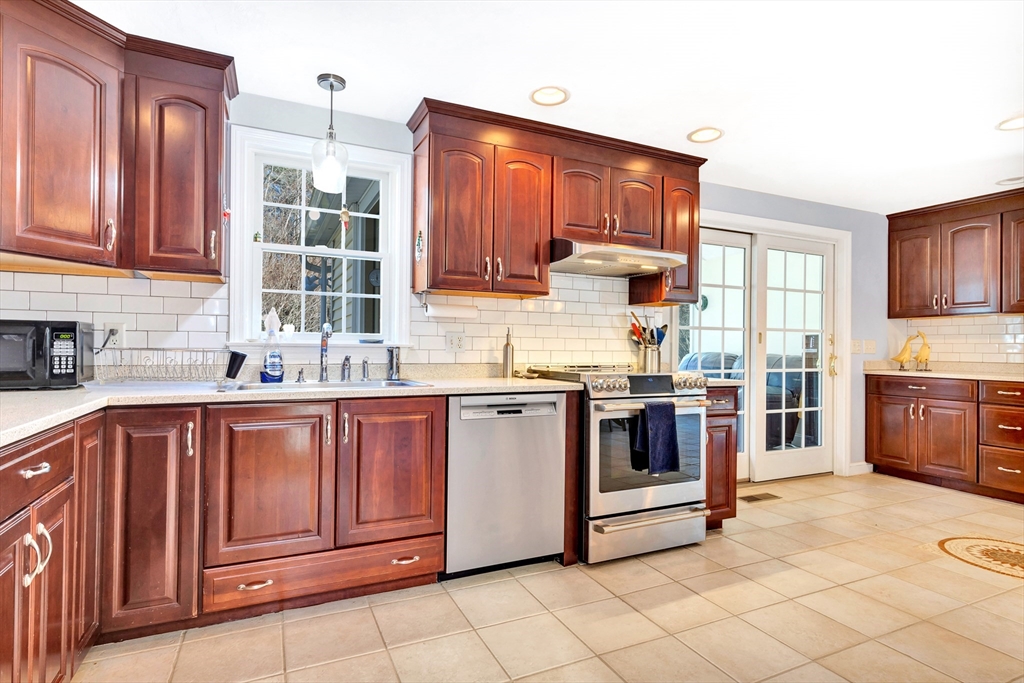 105 Hadley Road Merrimac, MA 01860 - Photo 8 of 31 a kitchen with stainless steel appliances granite countertop a stove sink and cabinets