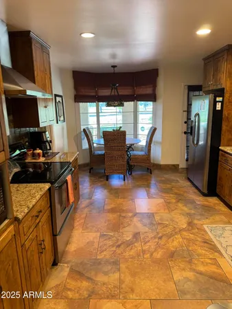 a stove top oven sitting inside of a kitchen