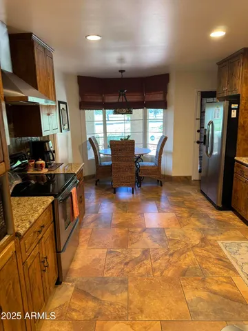a stove top oven sitting inside of a kitchen