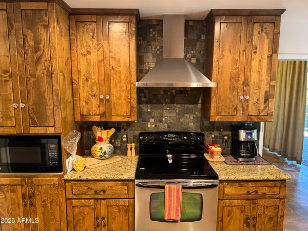 a kitchen with granite countertop a sink stainless steel appliances and cabinets