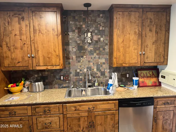 a kitchen with stainless steel appliances a sink stove and cabinets