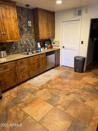 a bedroom with a bed dresser and a window