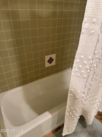 a bed sitting in a bedroom next to a lamp