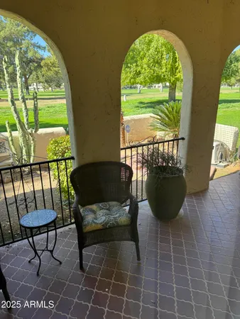 a view of a porch with furniture and a yard