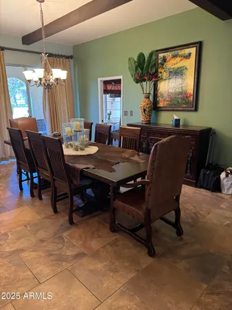 a view of a dining room with furniture and a chandelier