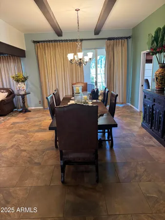 a living room with patio furniture and a flat screen tv