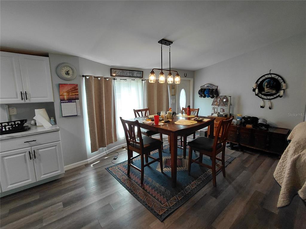 6758 North Capri Loop Hernando, FL 34442 - Photo 11 of 47 a view of a dining room with furniture window and wooden floor