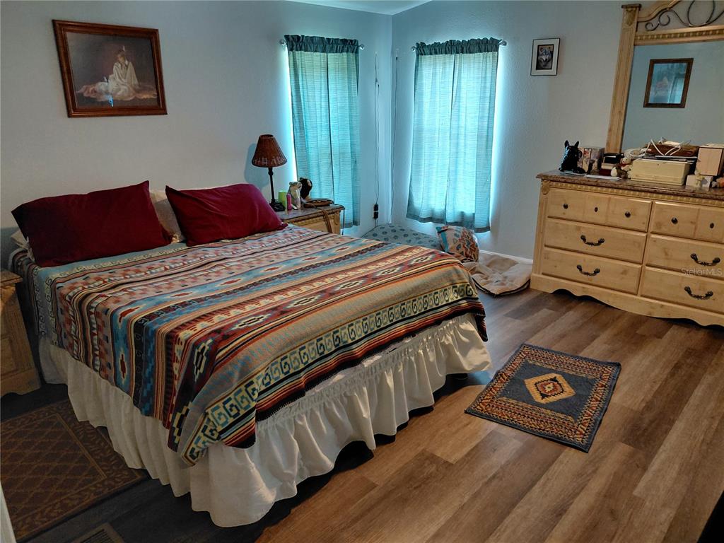 6758 North Capri Loop Hernando, FL 34442 - Photo 14 of 47 a bedroom with a bed and a dresser