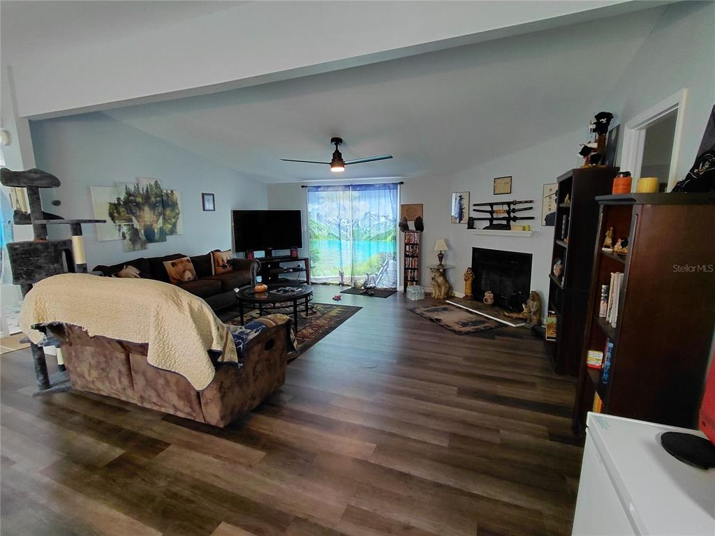 6758 North Capri Loop Hernando, FL 34442 - Photo 15 of 47 a living room with furniture flat screen tv and a fireplace