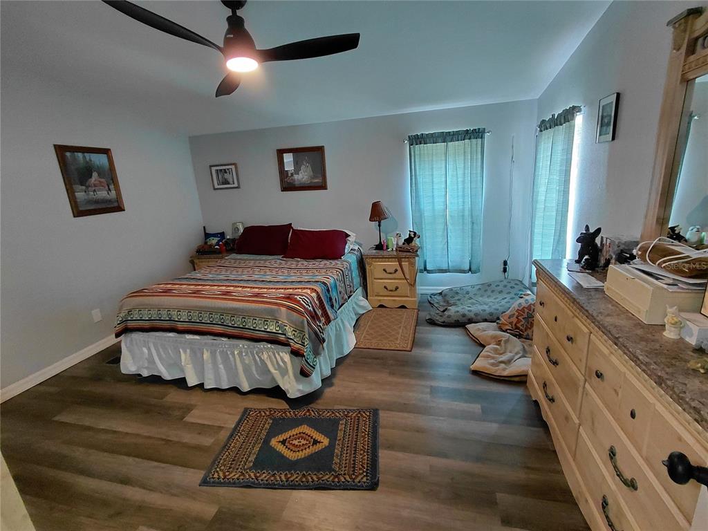 6758 North Capri Loop Hernando, FL 34442 - Photo 17 of 47 a bedroom with bed and wooden floor