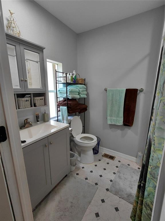 6758 North Capri Loop Hernando, FL 34442 - Photo 18 of 47 a bathroom with a sink toilet and mirror