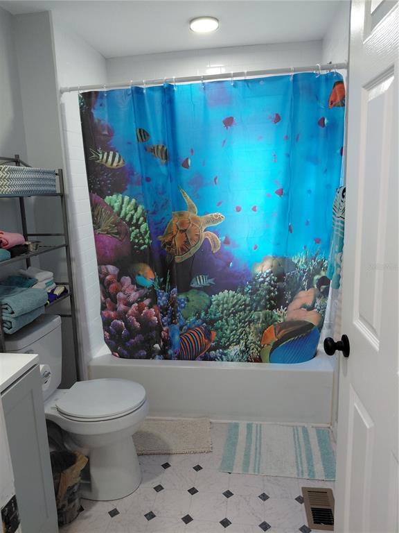 6758 North Capri Loop Hernando, FL 34442 - Photo 25 of 47 a bathroom with a toilet sink and garden view