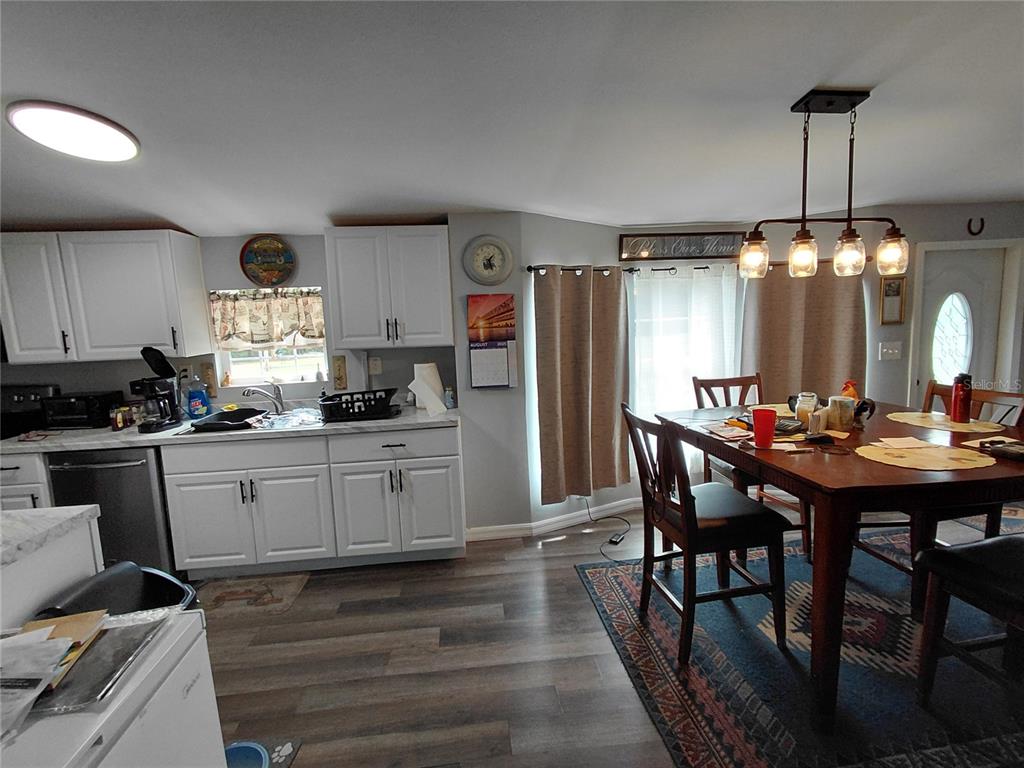 6758 North Capri Loop Hernando, FL 34442 - Photo 30 of 47 a kitchen with kitchen island a dining table chairs stainless steel appliances and cabinets