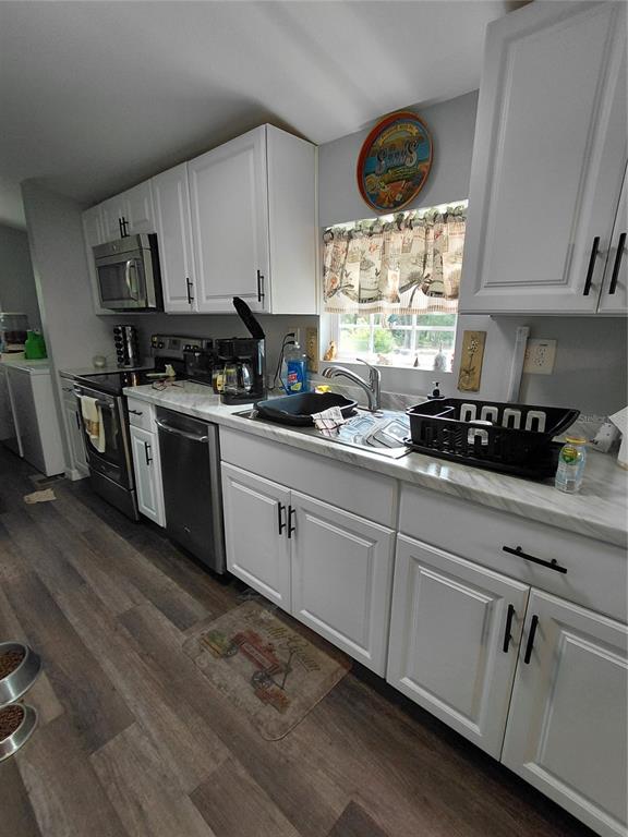 6758 North Capri Loop Hernando, FL 34442 - Photo 4 of 47 a kitchen with cabinets appliances a window and a counter space