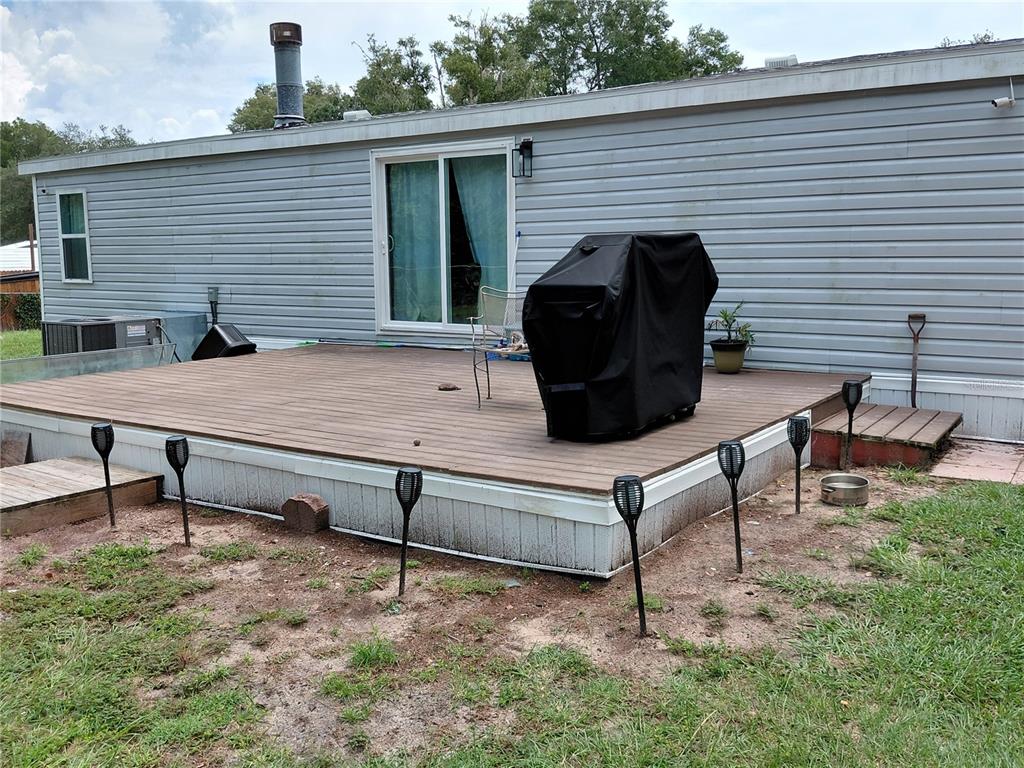 6758 North Capri Loop Hernando, FL 34442 - Photo 45 of 47 a view of a chairs and table in the back yard of the house
