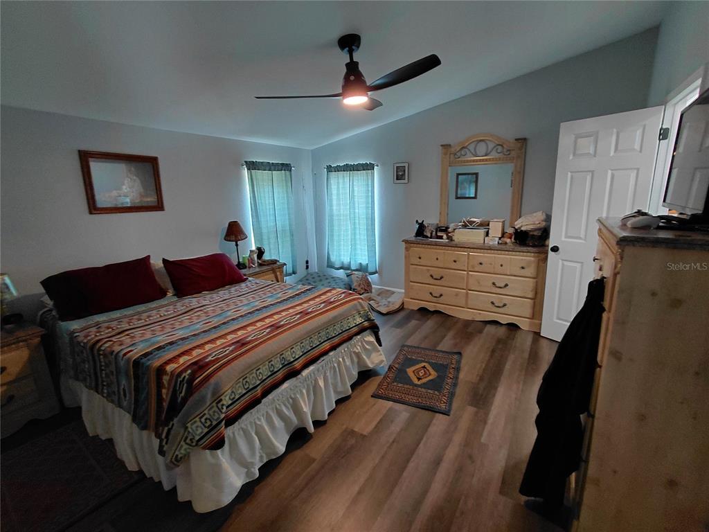 6758 North Capri Loop Hernando, FL 34442 - Photo 8 of 47 a bedroom with a bed and a chandelier