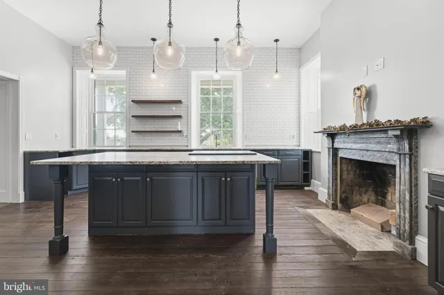 a kitchen with granite countertop a sink stove and cabinets