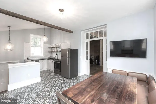a view of a room with wooden floor and windows