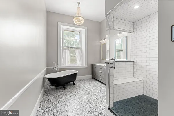 a bathroom with a double vanity sink mirror and shower