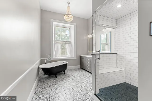 a bathroom with a double vanity sink mirror and shower