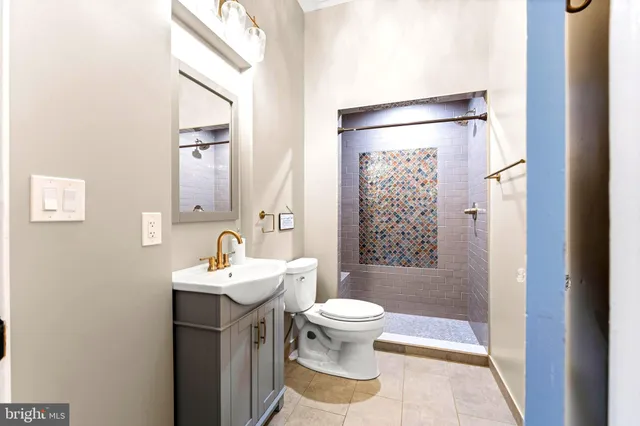 a bathroom with a toilet a sink and mirror