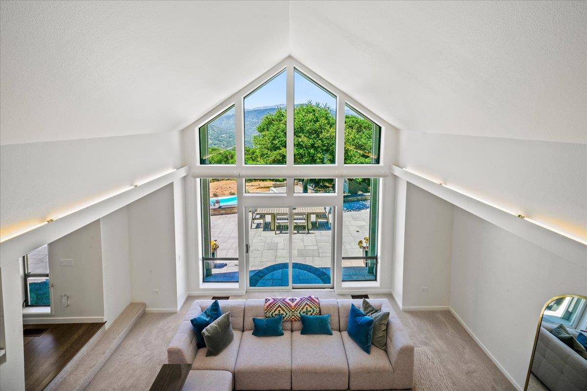 31499 Vía Las Rosas Carmel Valley, CA 93924 - Photo 15 of 44 a living room with furniture and a large window