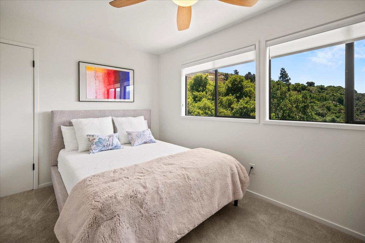 31499 Vía Las Rosas Carmel Valley, CA 93924 - Photo 25 of 44 a bedroom with a bed and a large window