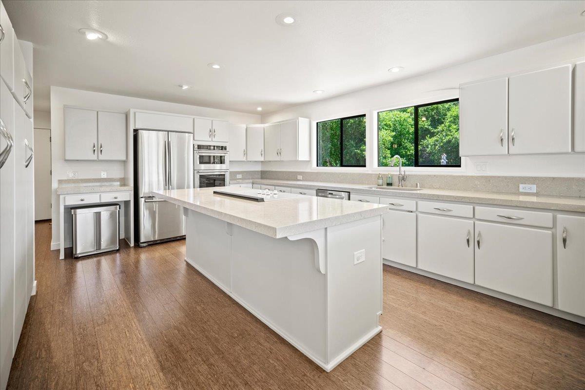31499 Vía Las Rosas Carmel Valley, CA 93924 - Photo 4 of 44 a kitchen with white cabinets and white appliances