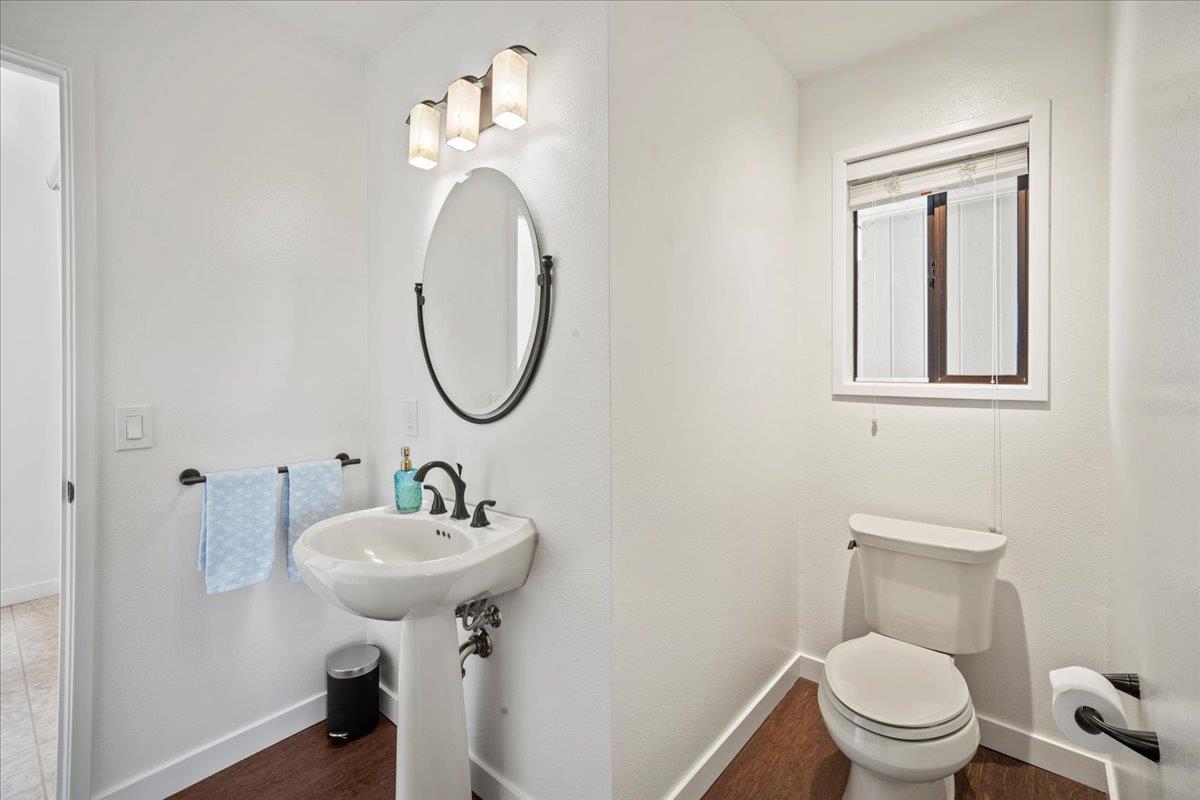 31499 Vía Las Rosas Carmel Valley, CA 93924 - Photo 6 of 44 a bathroom with a sink a mirror and a toilet