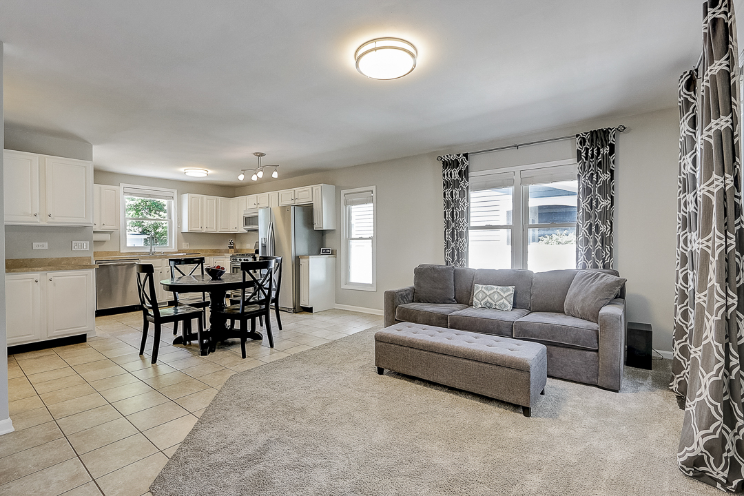 1025 North Main Street Naperville, IL 60563 - Photo 2 of 28 a living room with furniture and a large window