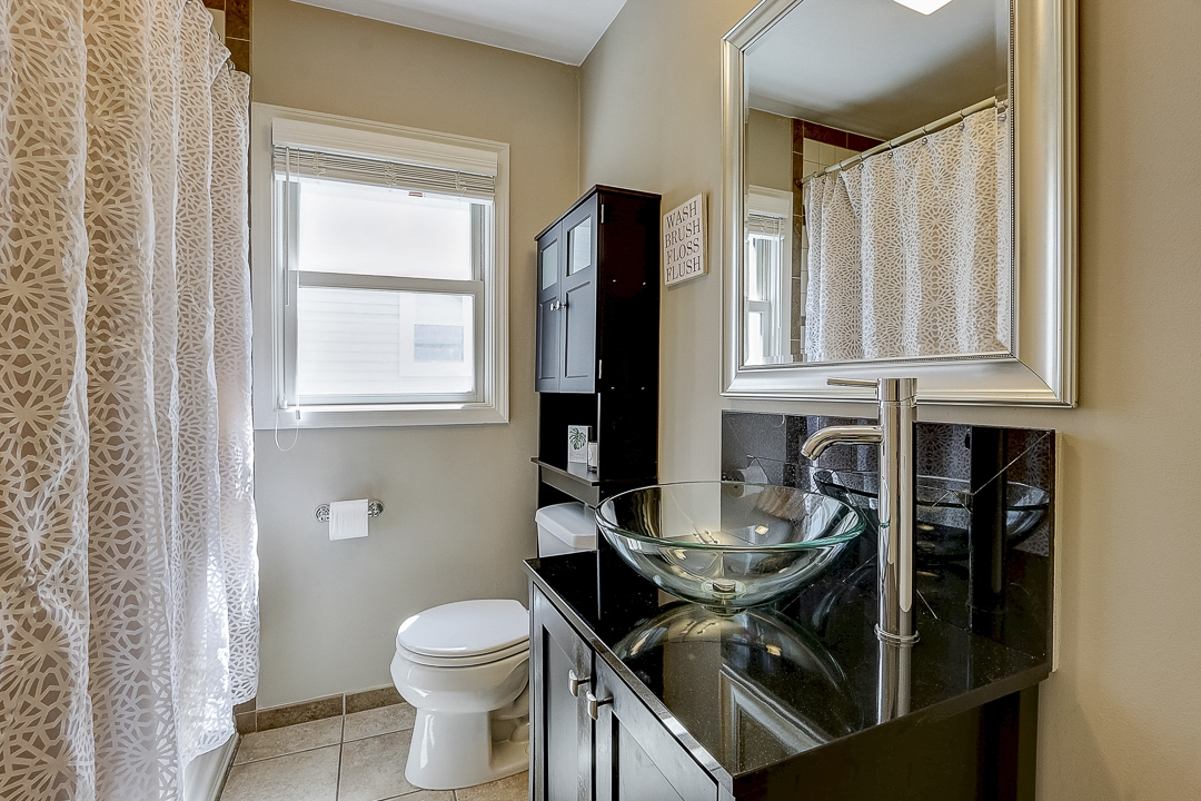 1025 North Main Street Naperville, IL 60563 - Photo 11 of 28 a bathroom with a granite countertop sink and a toilet