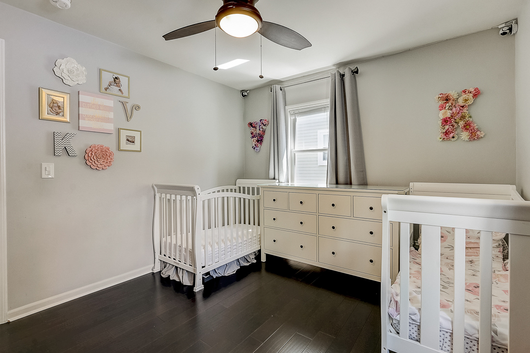 1025 North Main Street Naperville, IL 60563 - Photo 13 of 28 a bedroom with a bed and a chandelier