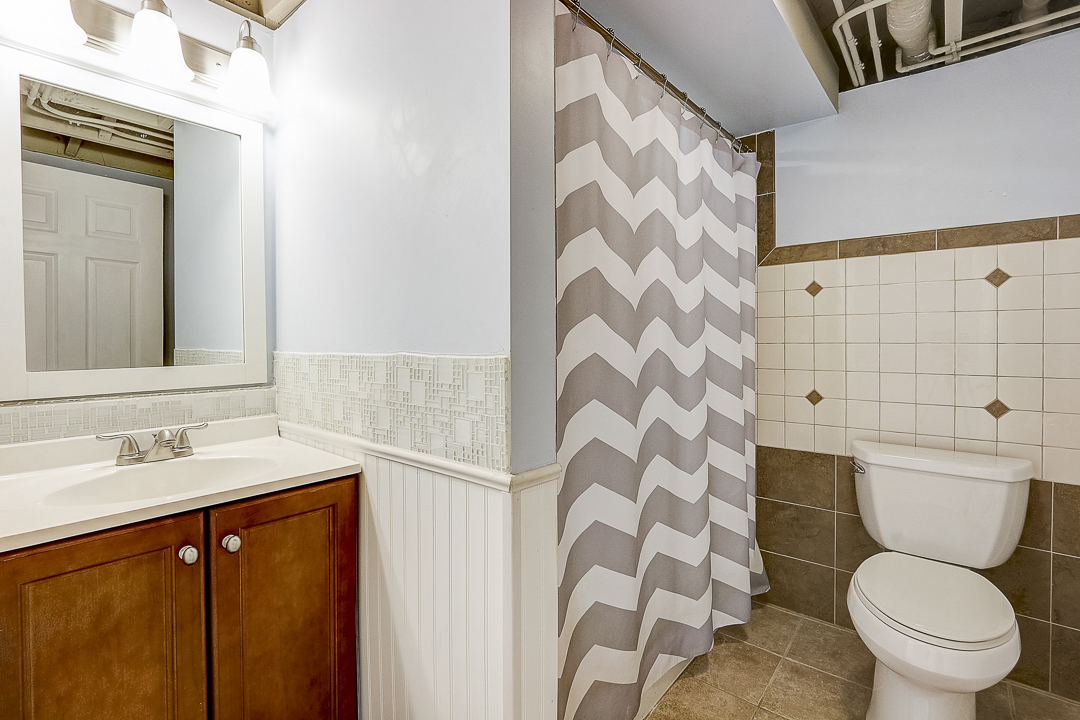 1025 North Main Street Naperville, IL 60563 - Photo 19 of 28 a bathroom with a sink and toilet