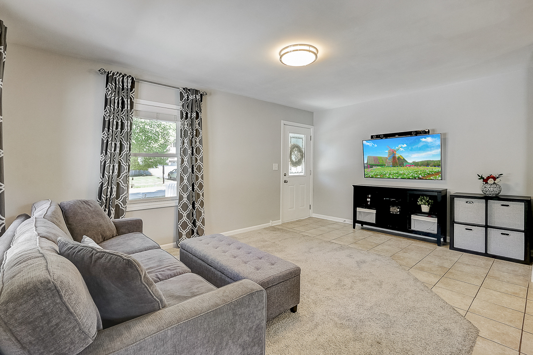 1025 North Main Street Naperville, IL 60563 - Photo 3 of 28 a living room with furniture a window and a flat screen tv