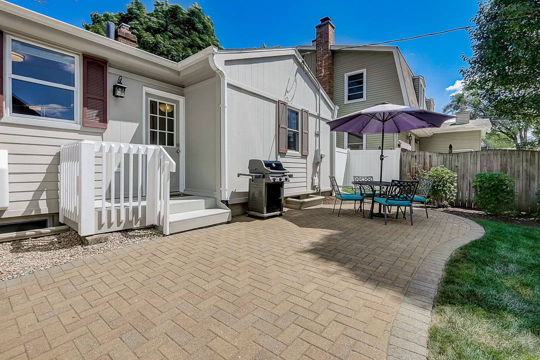 1025 North Main Street Naperville, IL 60563 - Photo 22 of 28 a patio with a table and chairs under an umbrella