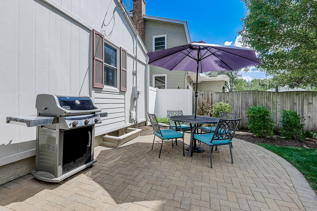 1025 North Main Street Naperville, IL 60563 - Photo 23 of 28 a view of a patio with a table and chairs under an umbrella