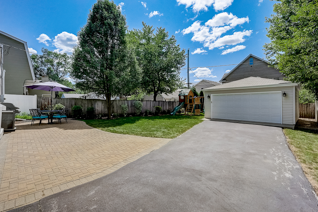 1025 North Main Street Naperville, IL 60563 - Photo 25 of 28 a front view of a house with a yard and outdoor seating